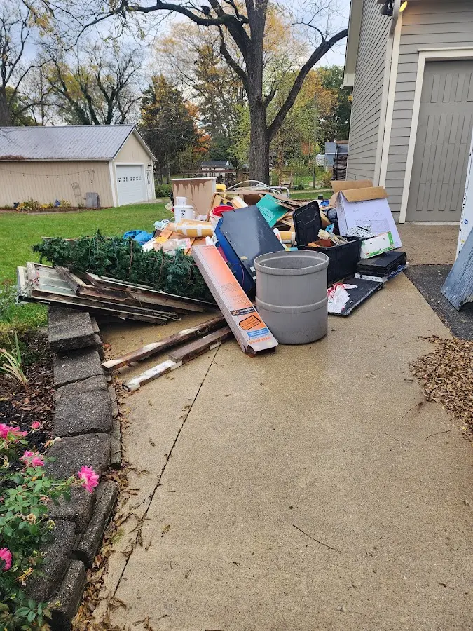 Dumpster being loaded with debris for 12 Yard Dumpster Rental in Lompoc